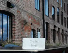 A paving brick engraved with the name Charles Bage, resting on a table outside Shrewsbury Flaxmill M