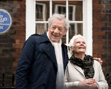 Sir Ian McKellen and Dame Judy Dench looking cheerful in front of the Blue 
