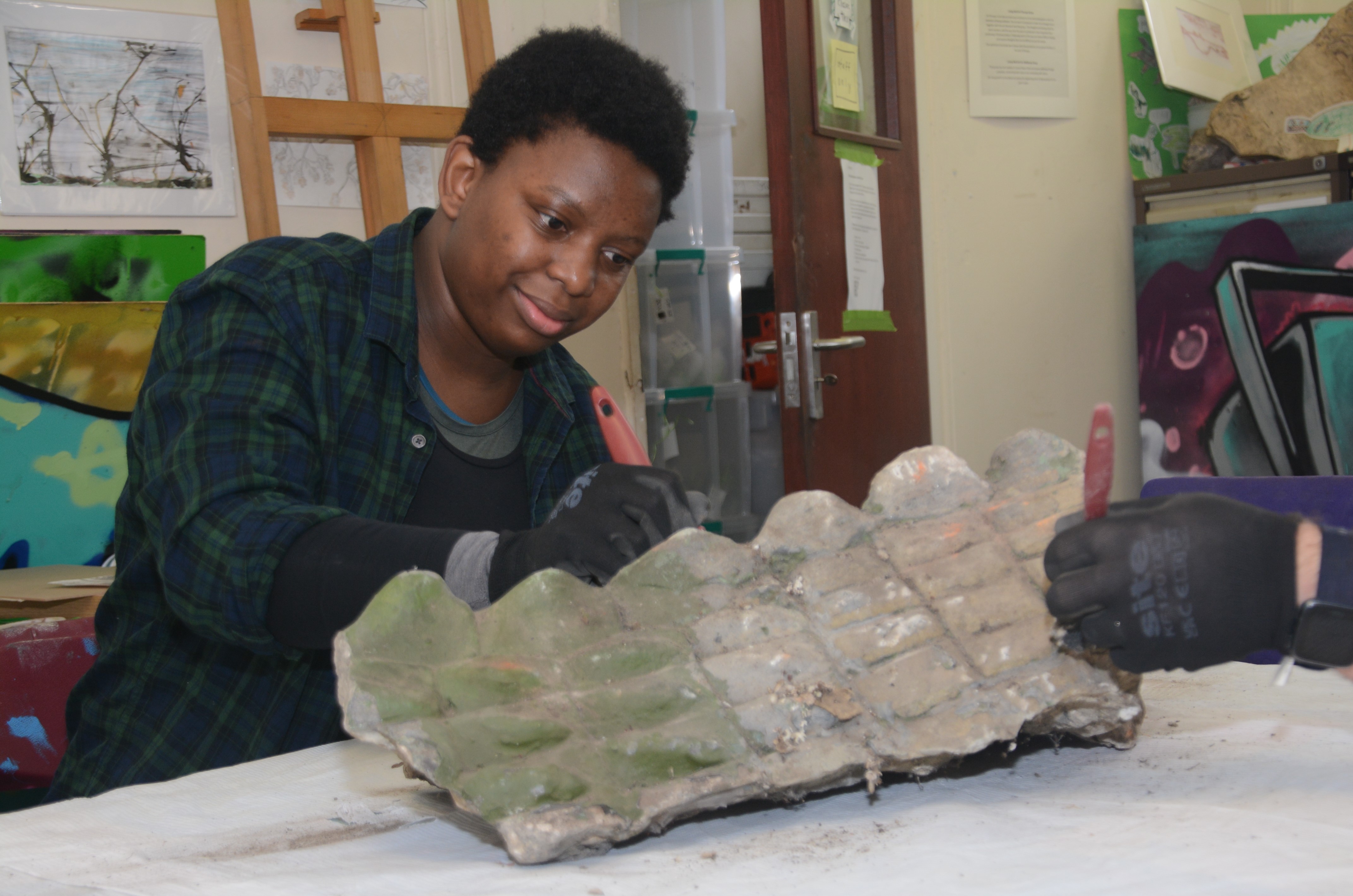 A person conserving plasterwork.