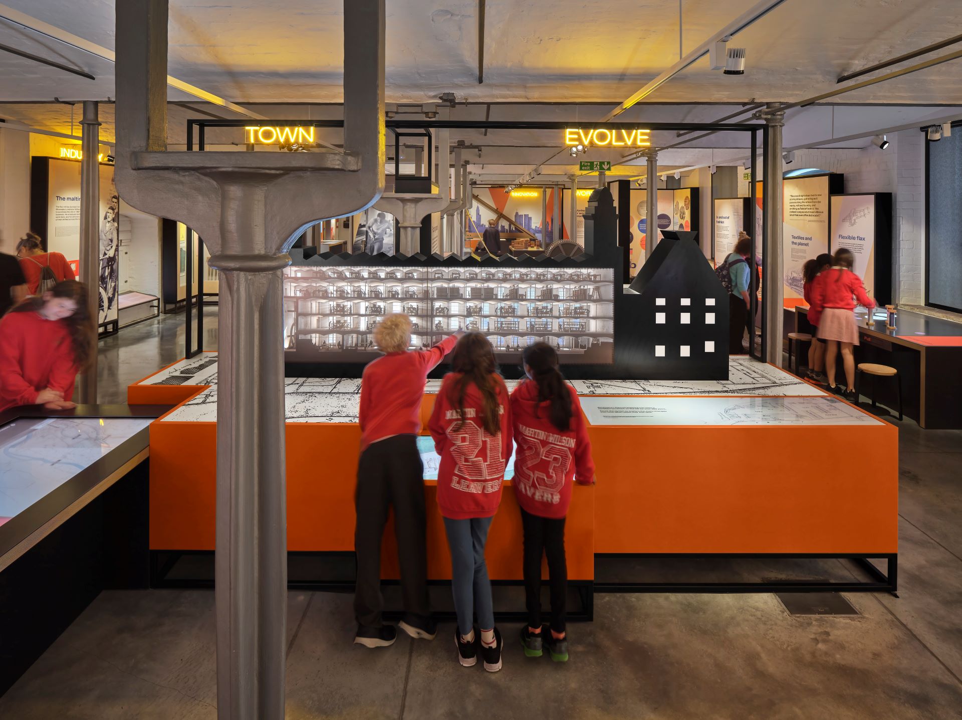 Three children pointing and looking at an exhibit on display at Shrewsbury 